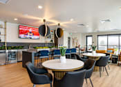Thumbnail 23 of 29 - A modern dining area with a round table and chairs.