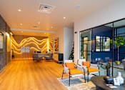 Thumbnail 21 of 29 - A modern living room with a wooden floor and a large window.