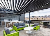 Thumbnail 11 of 29 - A modern outdoor seating area with a view of the mountains.