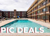 Thumbnail 1 of 31 - A pool in front of apartment buildings with the words "EPIC DEALS" superimposed on the image.