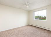 Thumbnail 16 of 31 - an empty bedroom with a ceiling fan and a window
