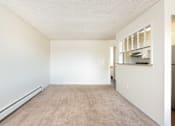 Thumbnail 15 of 31 - a spacious living room with white walls and a carpeted floor