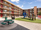 Thumbnail 7 of 31 - a playground in the courtyard of an apartment building