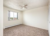 Thumbnail 29 of 31 - an empty bedroom with a ceiling fan and a window