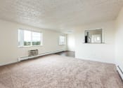 Thumbnail 22 of 31 - the living room and dining room of an apartment with carpeting and a large window