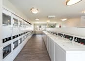 Thumbnail 26 of 35 - a laundry room filled with washers and dryer machines