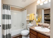 Thumbnail 11 of 35 - a bathroom with a shower and a sink and a toilet