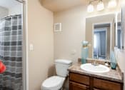 Thumbnail 23 of 35 - a bathroom with a toilet sink and mirror and a shower