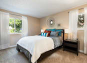 Thumbnail 19 of 35 - a bedroom with a bed and two windows