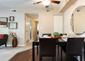 Thumbnail 18 of 35 - a dining room with a table and chairs and a mirror