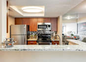 Thumbnail 6 of 50 - a kitchen with stainless steel appliances and granite counter tops