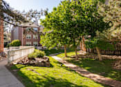Thumbnail 23 of 50 - a sidewalk and trees in front of a brick building