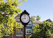 Thumbnail 36 of 50 - a clock on a pole in front of a building