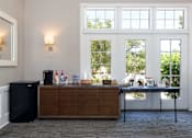 Thumbnail 44 of 50 - a bar in a room with large windows and a table with drinks on it