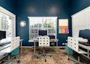 Thumbnail 40 of 50 - a computer room with desks and chairs and a computer monitor
