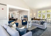 Thumbnail 42 of 50 - a living room with couches and chairs and a table