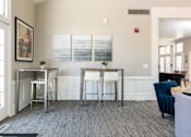 Thumbnail 43 of 50 - a living room with two bar stools in front of a window and a couch