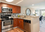 Thumbnail 17 of 50 - a kitchen with stainless steel appliances and a counter top