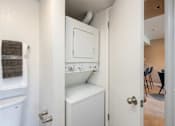 Thumbnail 22 of 50 - a washer and dryer in a small closet in a room with a door