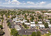 Thumbnail 31 of 39 - an aerial view of a suburb of a city with a road and cars