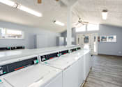 Thumbnail 17 of 39 - a laundry room with washes and dryers in it