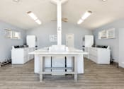 Thumbnail 18 of 39 - a kitchen with white appliances and a white table