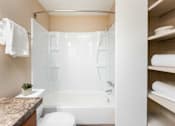 Thumbnail 9 of 39 - a bathroom with a shower and a toilet and a sink