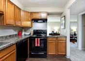 Thumbnail 5 of 39 - a kitchen with black appliances and wooden cabinets