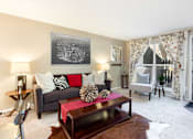 Thumbnail 1 of 39 - a living room with a couch and a coffee table