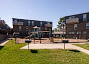 Thumbnail 20 of 39 - a playground in the middle of an apartment complex