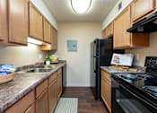 Thumbnail 5 of 34 - our apartments have a modern kitchen with granite counter tops and black appliances