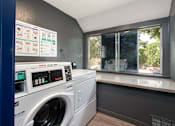 Thumbnail 18 of 34 - a laundry room with a washing machine and a window