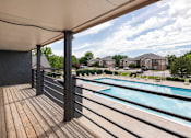 Thumbnail 11 of 34 - the view of a swimming pool from a balcony with wooden decking
