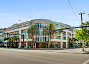 Thumbnail 15 of 31 - a large building on the corner of a street with palm trees