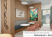 Thumbnail 4 of 34 - A room with a wooden wall and a painting of a plant.