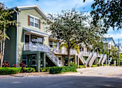 Thumbnail 16 of 31 - a row of apartment buildings with stairs and trees