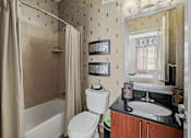 Thumbnail 14 of 31 - a bathroom with a sink toilet and a shower