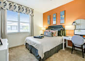 Thumbnail 13 of 31 - a bedroom with a bed and a desk