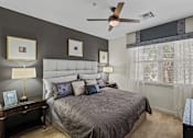 Thumbnail 6 of 31 - a bedroom with a bed and a ceiling fan