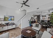 Thumbnail 10 of 31 - a living room with furniture and a ceiling fan