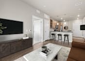 Thumbnail 3 of 39 - A modern living room with a brown sofa and a coffee table.