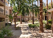 Thumbnail 37 of 43 - a courtyard with trees and a sidewalk in front of an apartment building
