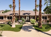 Thumbnail 31 of 43 - a house with palm trees and a sign in front of it