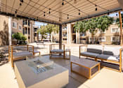 Thumbnail 23 of 43 - a patio with couches and tables and a glass table