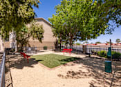 Thumbnail 28 of 43 - a dog park with grass and benches in front of a building