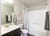 Thumbnail 11 of 43 - a bathroom with a shower toilet and sink and a mirror