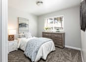 Thumbnail 9 of 43 - a bedroom with a bed and a dresser and a window