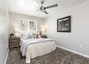 Thumbnail 12 of 43 - a bedroom with a bed and a ceiling fan