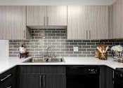 Thumbnail 8 of 43 - a kitchen with a sink and gray tiles