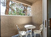 Thumbnail 16 of 43 - a balcony with a table and chairs and a window